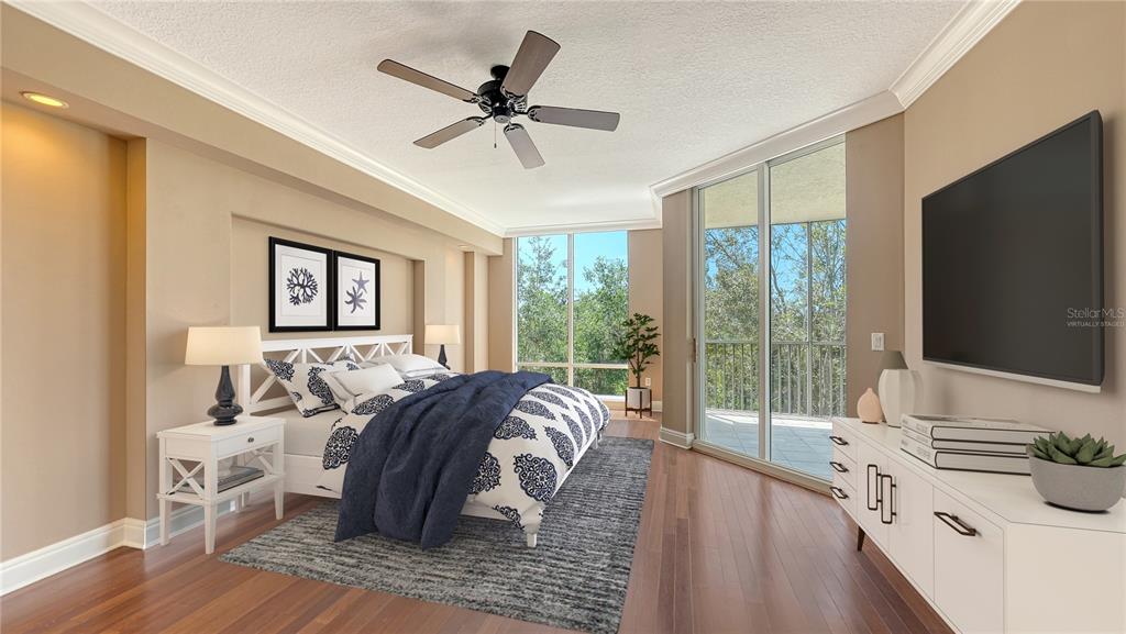 401 North Point Road, Unit 301 Osprey, FL 34229 - Photo 8 of 91 a living room with furniture and a flat screen tv