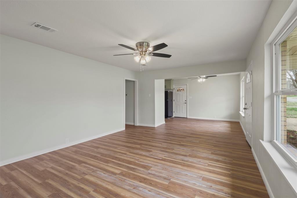 732 Bullock Street Denison, TX 75020 - Photo 5 of 29 wooden floor in an empty room with a window