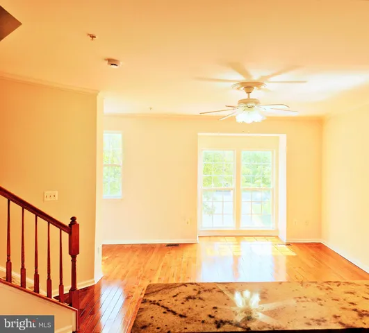 a view of a room with wooden floor and a window