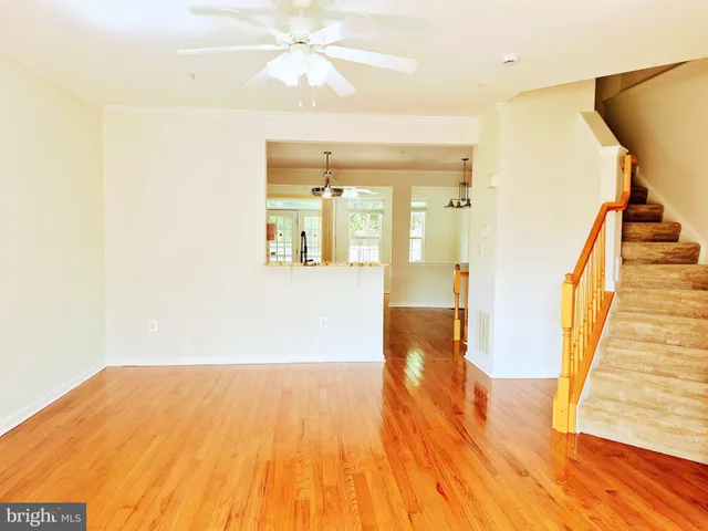 a view of a room with wooden floor and staircase