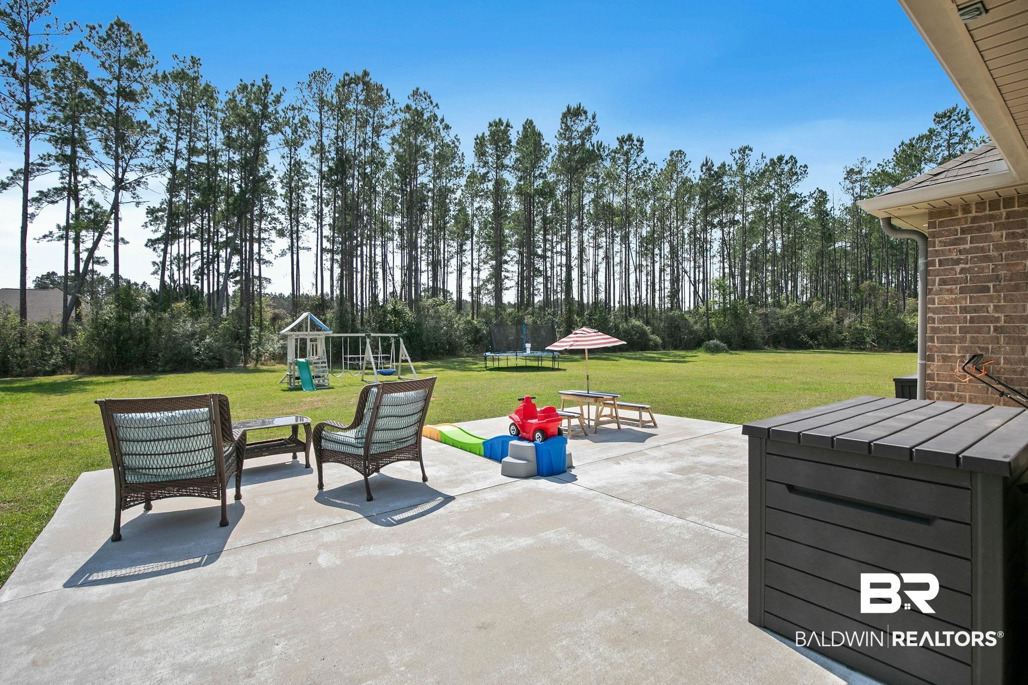 12750 B Jenkins Pit Road Daphne, AL 36527 - Photo 58 of 89 View of patio with a playground, a trampoline, and an outdoor lounge area