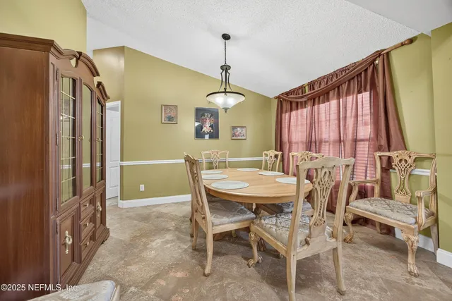 a living room with furniture and a ceiling fan