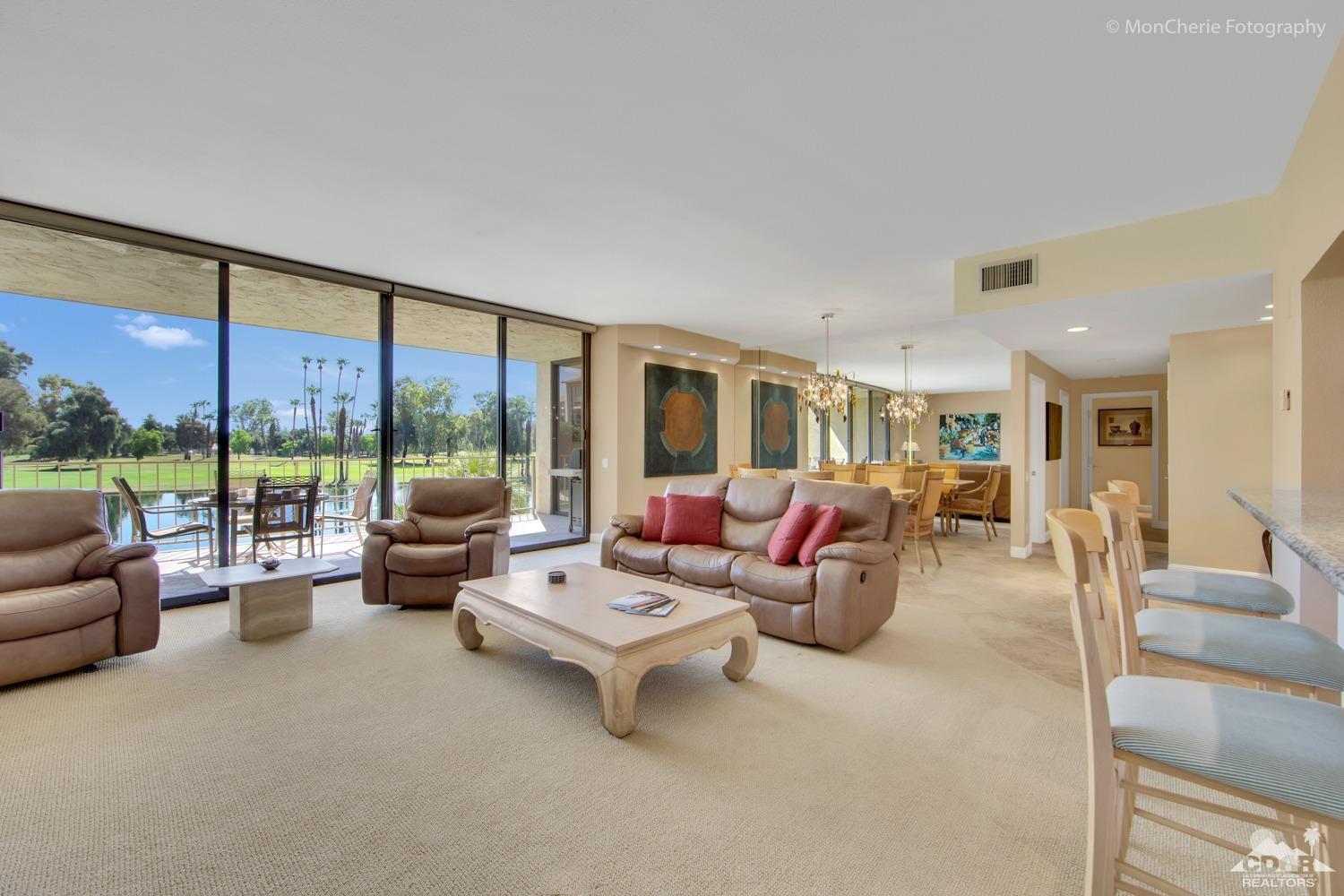 910 Island Drive, Unit 211 Rancho Mirage, CA 92270 - Photo 11 of 38 a living room with furniture and a large window