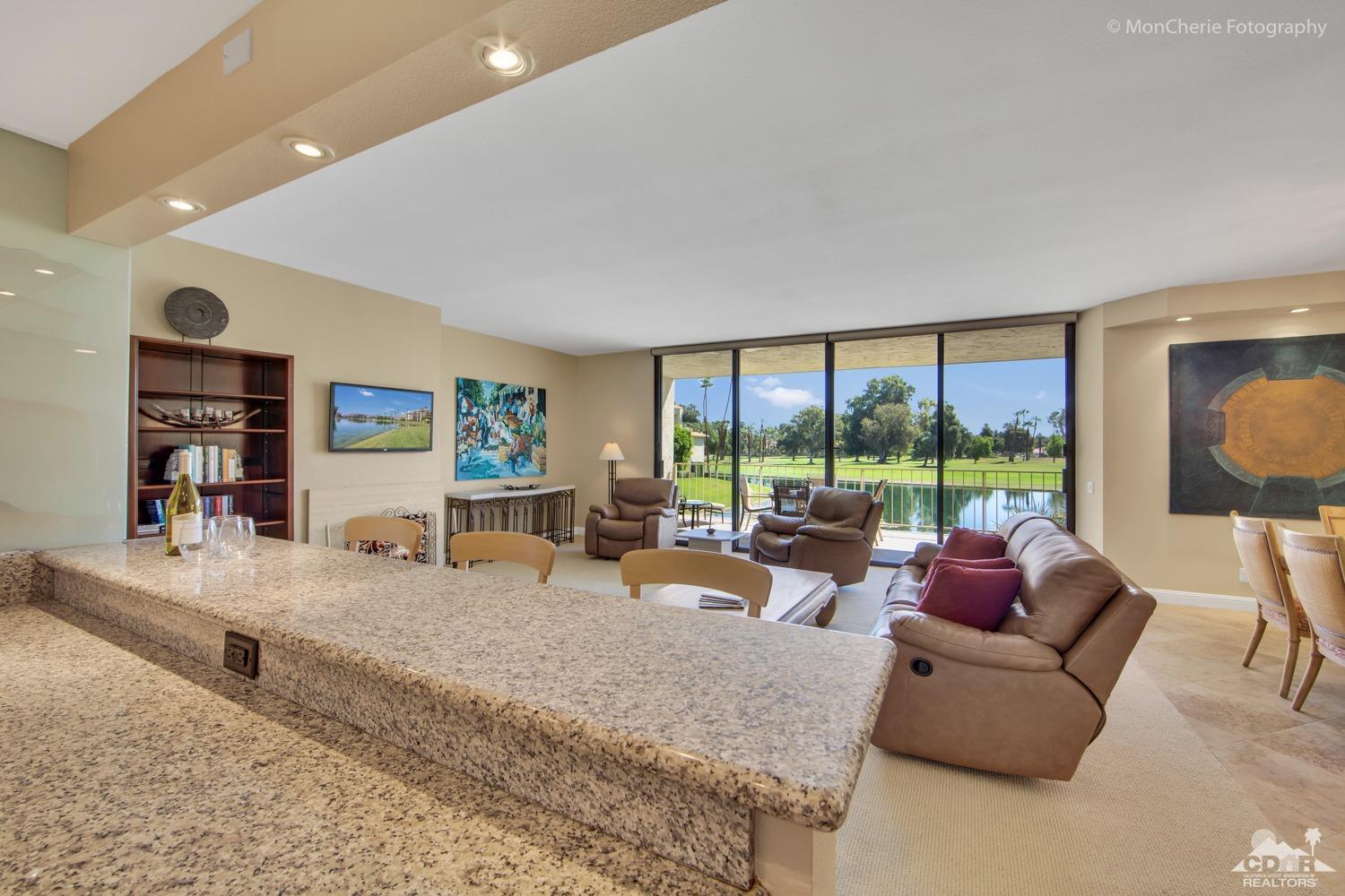 910 Island Drive, Unit 211 Rancho Mirage, CA 92270 - Photo 14 of 38 a living room with furniture and a large window
