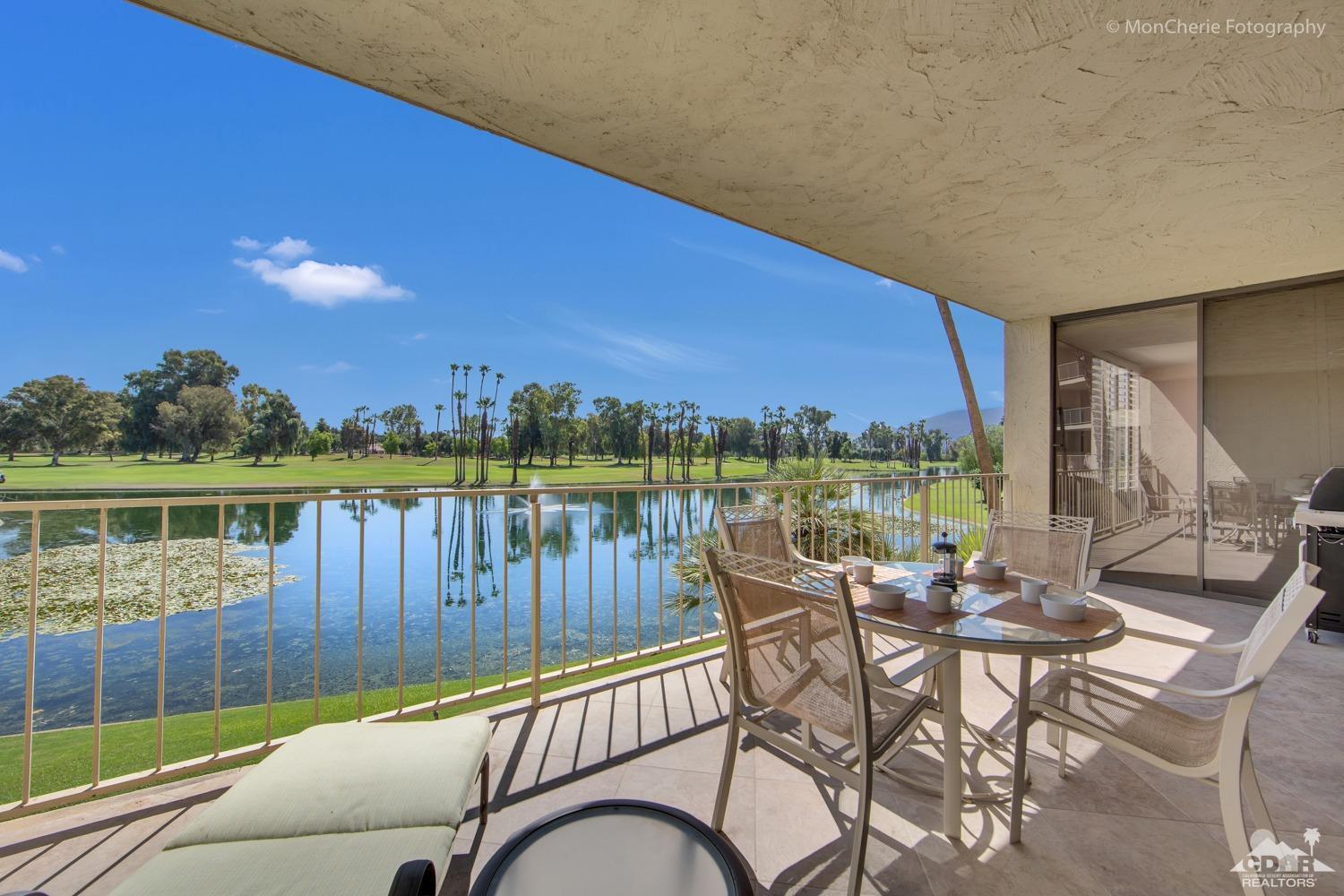 910 Island Drive, Unit 211 Rancho Mirage, CA 92270 - Photo 16 of 38 a view of a chairs and table in patio with a lake view