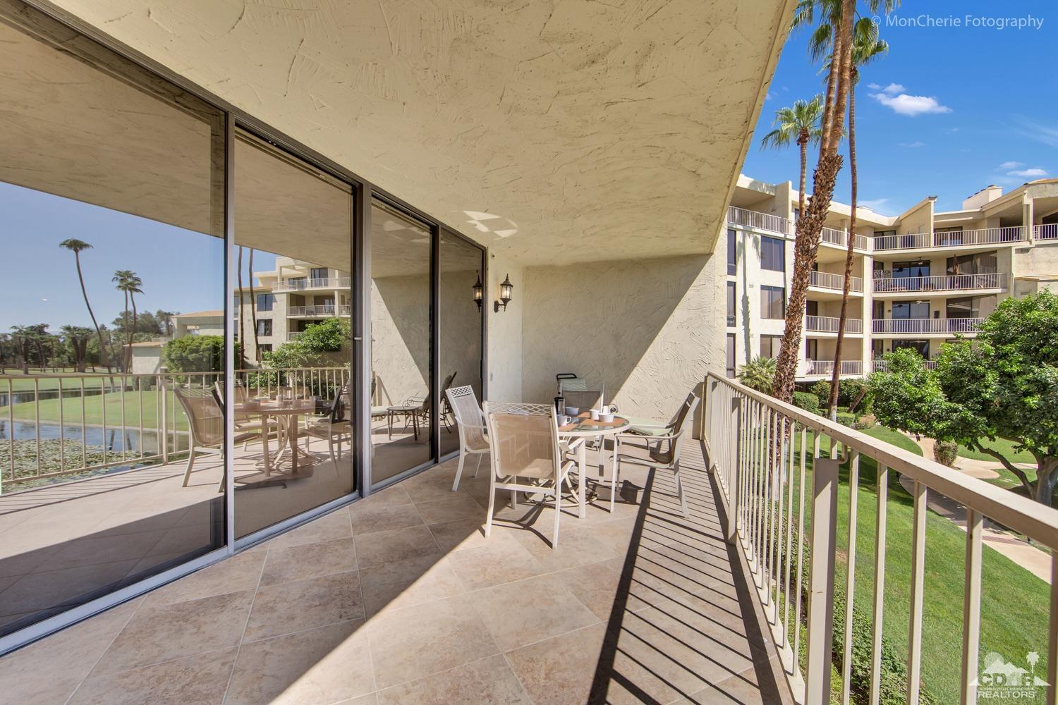910 Island Drive, Unit 211 Rancho Mirage, CA 92270 - Photo 17 of 38 a balcony with couch and wooden floor