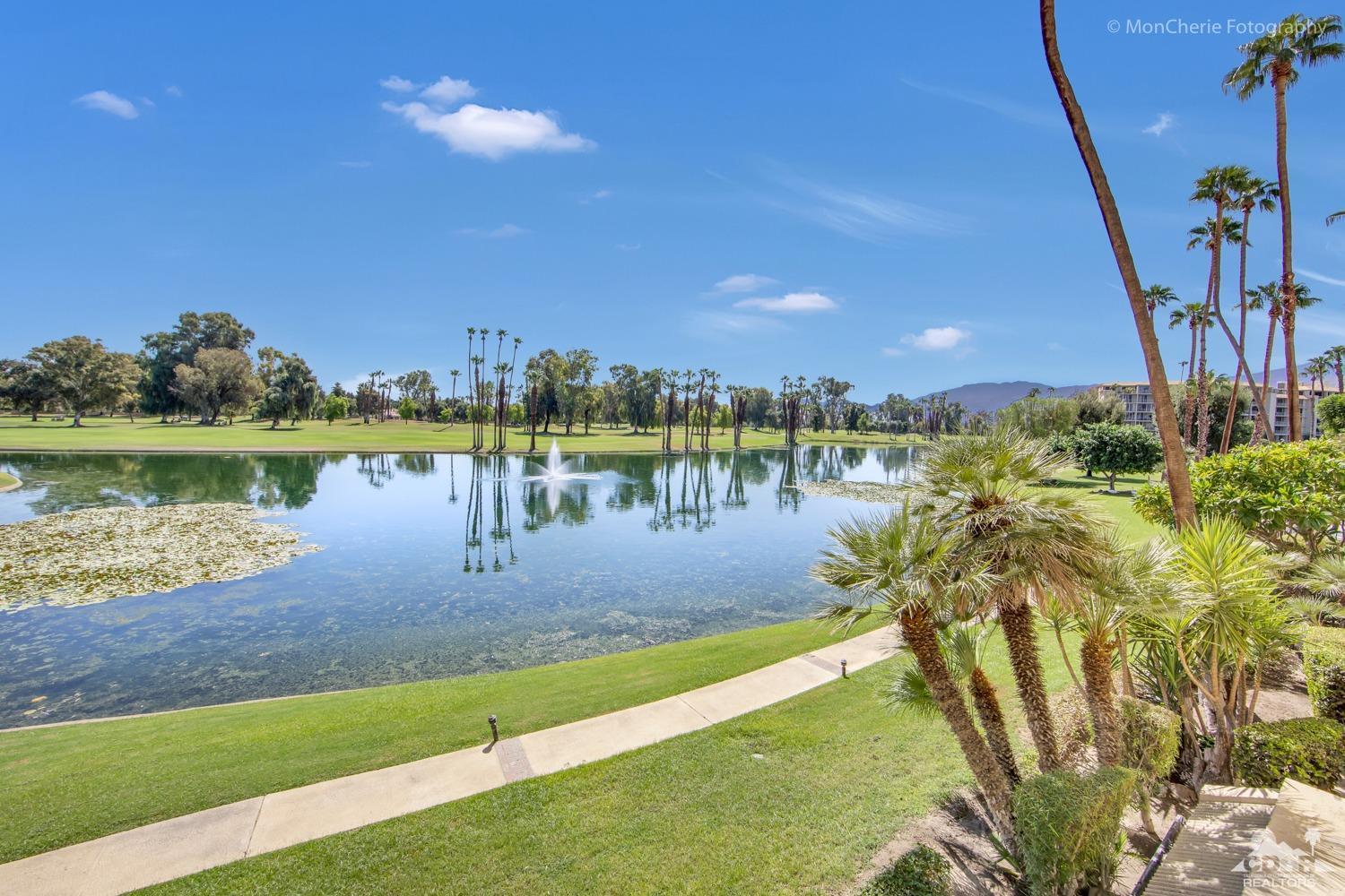 910 Island Drive, Unit 211 Rancho Mirage, CA 92270 - Photo 18 of 38 a view of a lake with houses