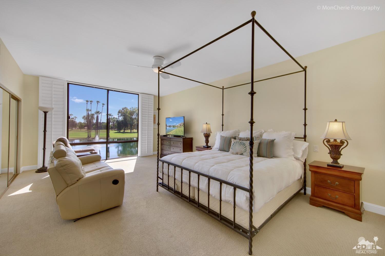 910 Island Drive, Unit 211 Rancho Mirage, CA 92270 - Photo 19 of 38 a bedroom with a bed and large window