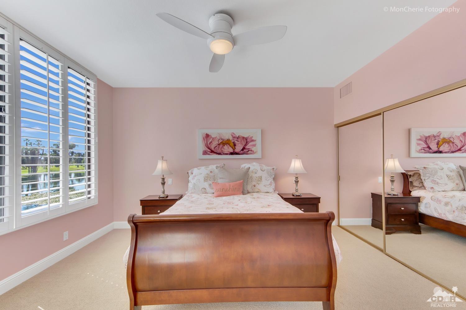 910 Island Drive, Unit 211 Rancho Mirage, CA 92270 - Photo 24 of 38 a bedroom with a bed and a large window