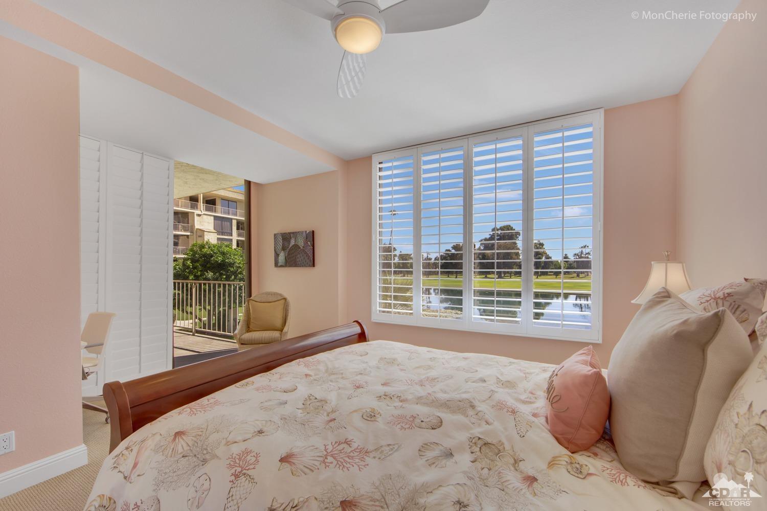 910 Island Drive, Unit 211 Rancho Mirage, CA 92270 - Photo 25 of 38 a bedroom with a bed and a large window