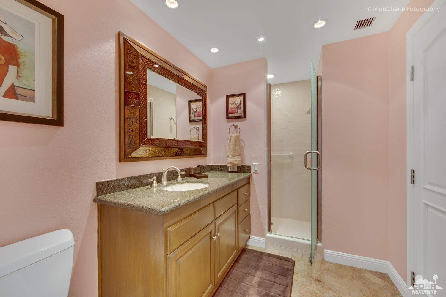 910 Island Drive, Unit 211 Rancho Mirage, CA 92270 - Photo 27 of 38 a bathroom with a sink and a mirror