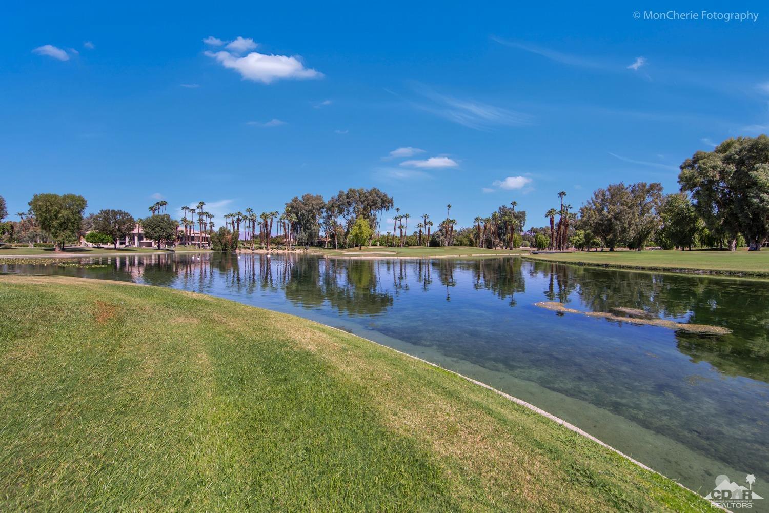 910 Island Drive, Unit 211 Rancho Mirage, CA 92270 - Photo 31 of 38 a view of a lake with houses in the back