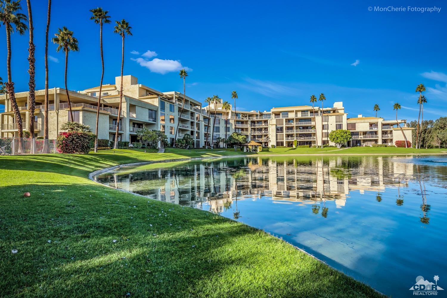 910 Island Drive, Unit 211 Rancho Mirage, CA 92270 - Photo 35 of 38 a view of a lake with a building in the background