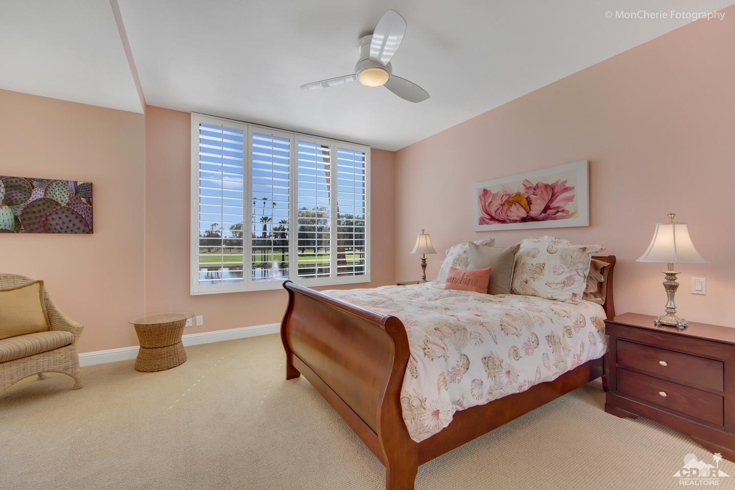 910 Island Drive, Unit 211 Rancho Mirage, CA 92270 - Photo 5 of 38 a spacious bedroom with a bed and a couch