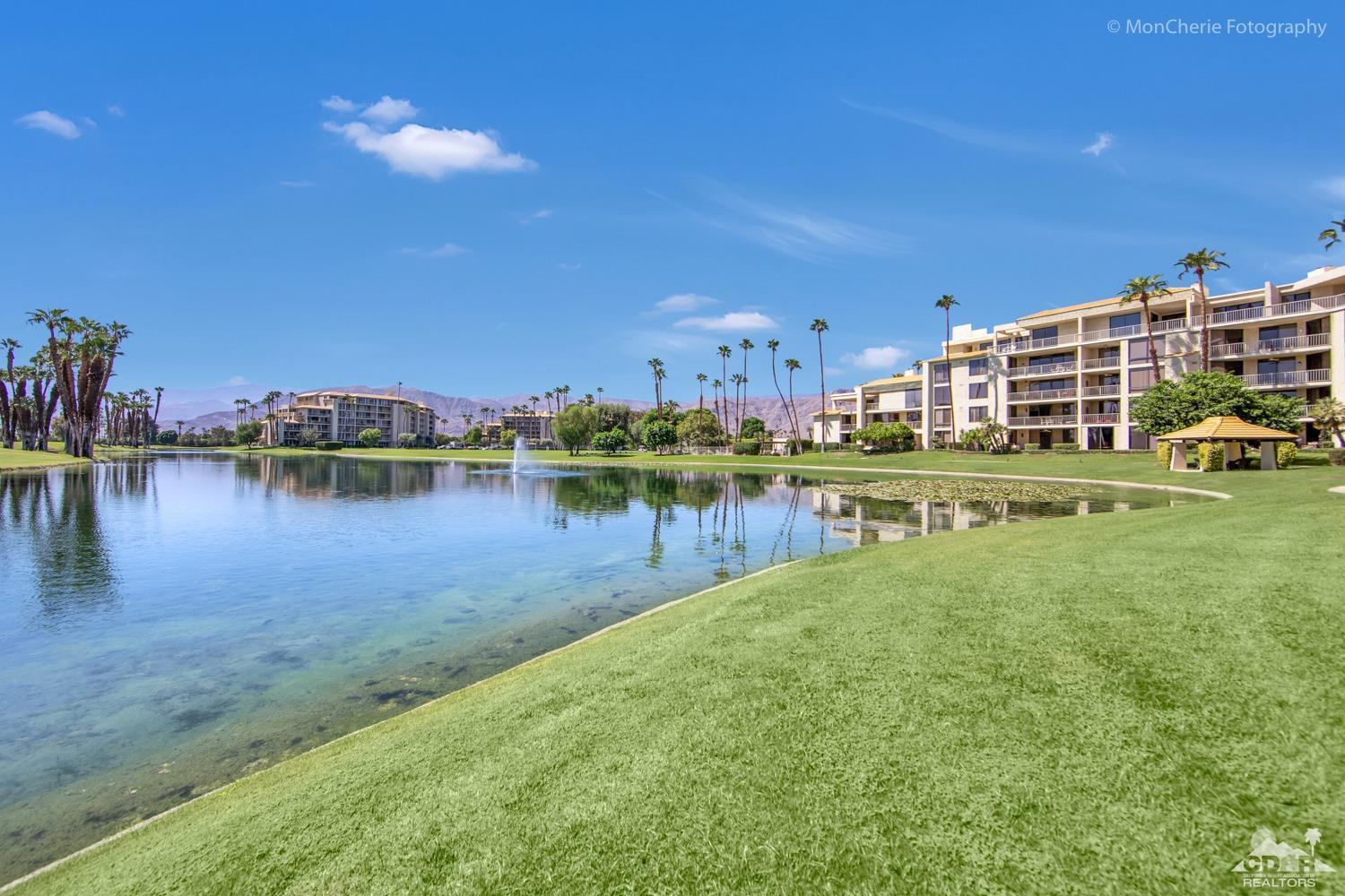 910 Island Drive, Unit 211 Rancho Mirage, CA 92270 - Photo 7 of 38 a view of a lake with building in front of it