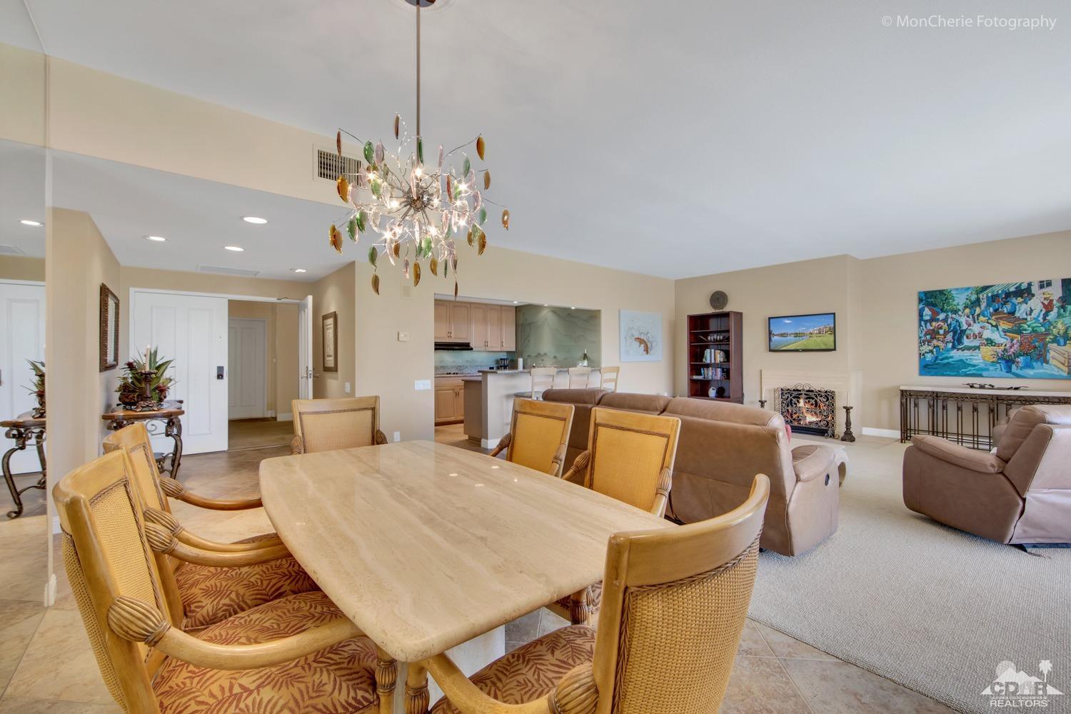 910 Island Drive, Unit 211 Rancho Mirage, CA 92270 - Photo 9 of 38 a view of a dining room with furniture and a chandelier
