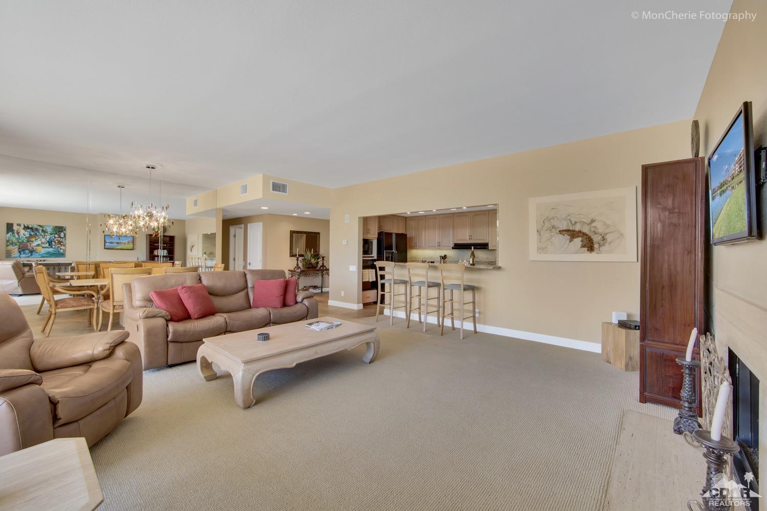 910 Island Drive, Unit 211 Rancho Mirage, CA 92270 - Photo 10 of 38 a living room with furniture and a flat screen tv