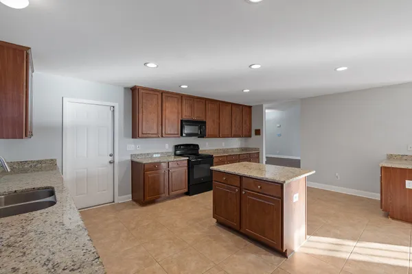 a kitchen with a sink stove and refrigerator