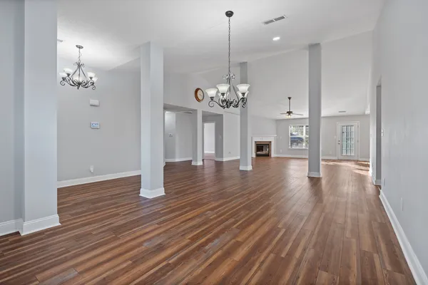 a view of a room with wooden floor