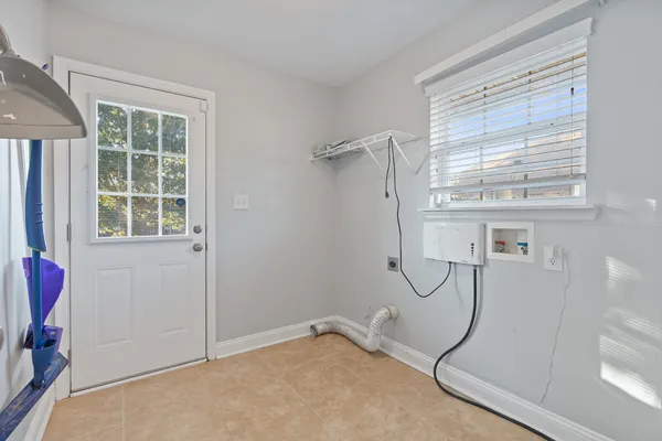 a bathroom with a granite countertop shower and a window