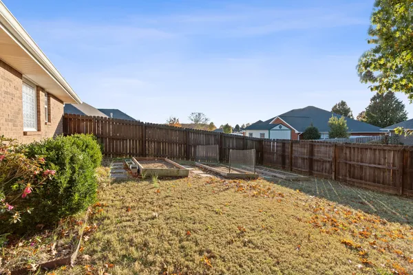 a backyard of a house with table and chairs