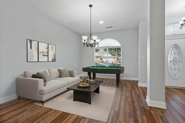a living room with furniture a window and a chandelier