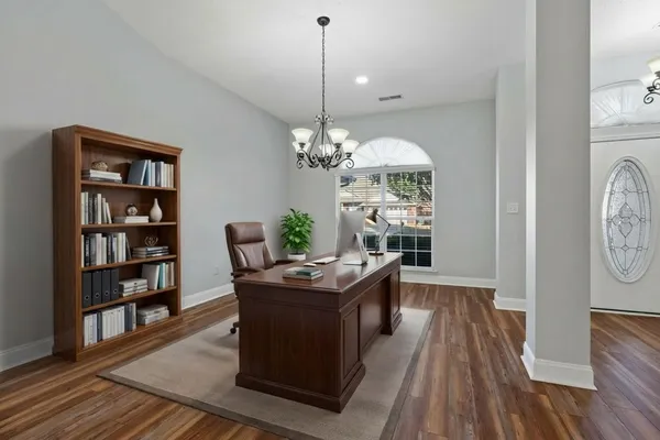 a dining room with furniture a rug and a chandelier