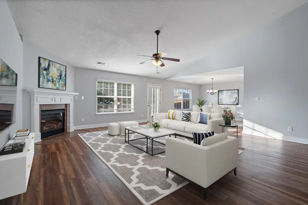 a living room with furniture fireplace and window