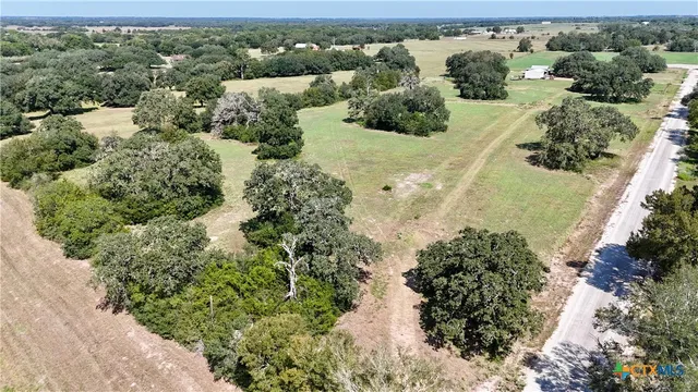 an aerial view of a houses with a yard