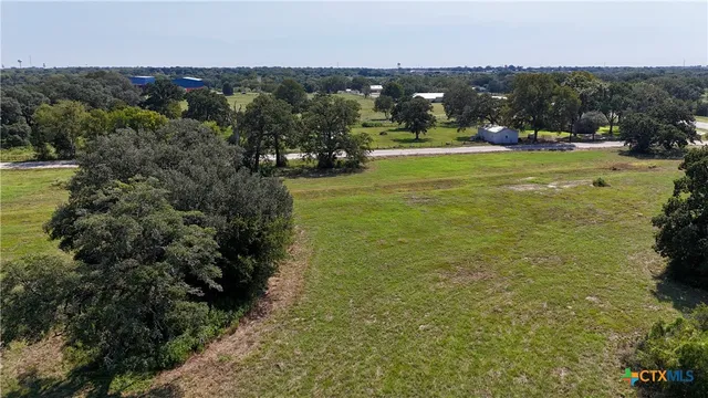 a view of a golf course with trees