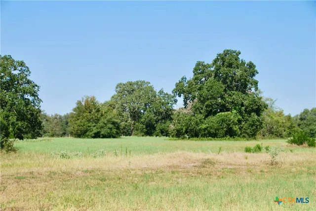 a view of a lake with a yard