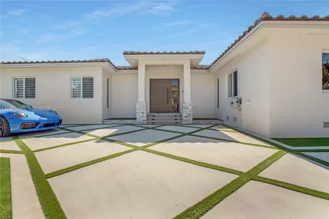 a living room with furniture and a mirror
