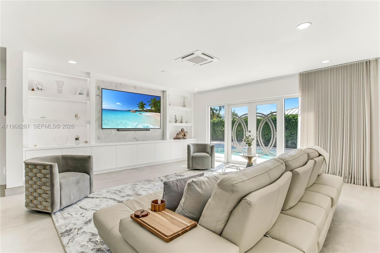 500 94th Street Surfside, FL 33154 - Photo 15 of 47 a living room with furniture and a flat screen tv