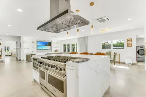 a kitchen with a sink cabinets and window