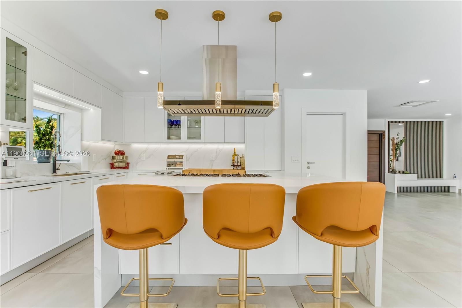 500 94th Street Surfside, FL 33154 - Photo 19 of 47 a kitchen with stainless steel appliances granite countertop a dining table chairs and sink