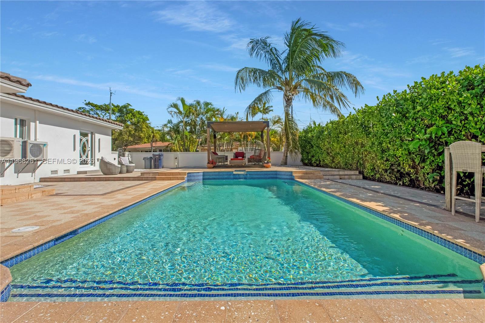 500 94th Street Surfside, FL 33154 - Photo 22 of 47 a front view of a house with garden