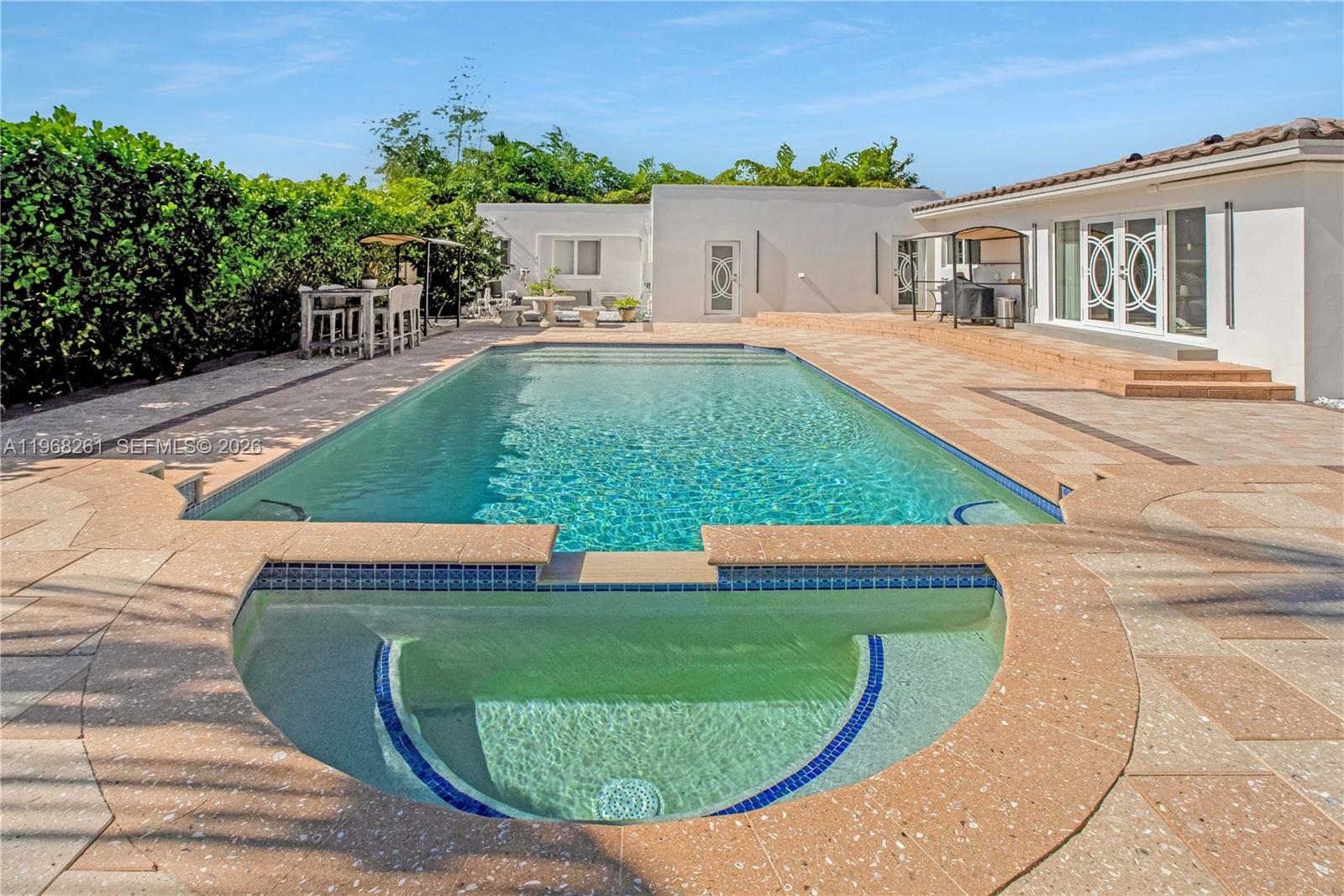 500 94th Street Surfside, FL 33154 - Photo 25 of 47 swimming pool view with a garden space