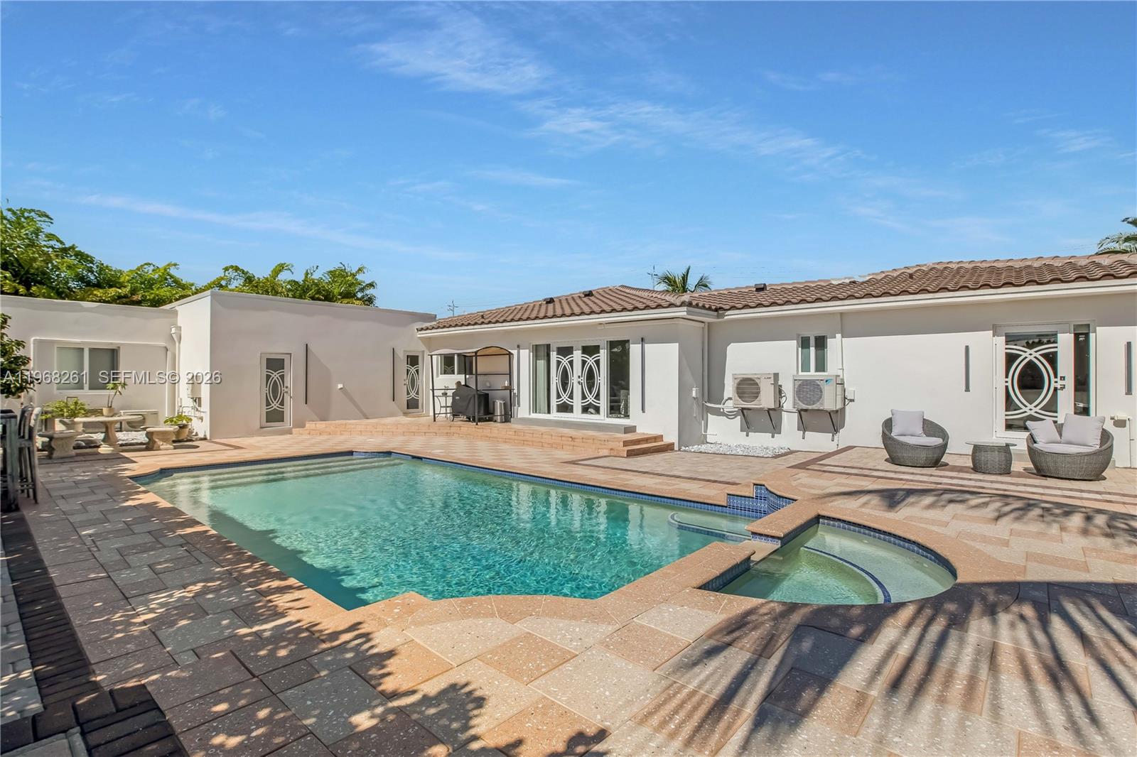 500 94th Street Surfside, FL 33154 - Photo 26 of 47 a view of a house with swimming pool and sitting area