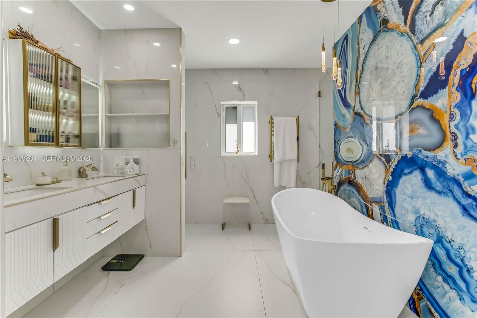 500 94th Street Surfside, FL 33154 - Photo 32 of 47 a spacious bathroom with a double vanity sink and a mirror