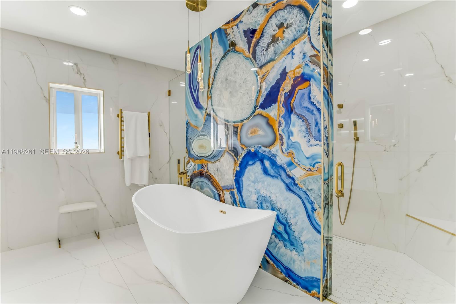 500 94th Street Surfside, FL 33154 - Photo 33 of 47 a bathroom with a sink and mirror with bathtub