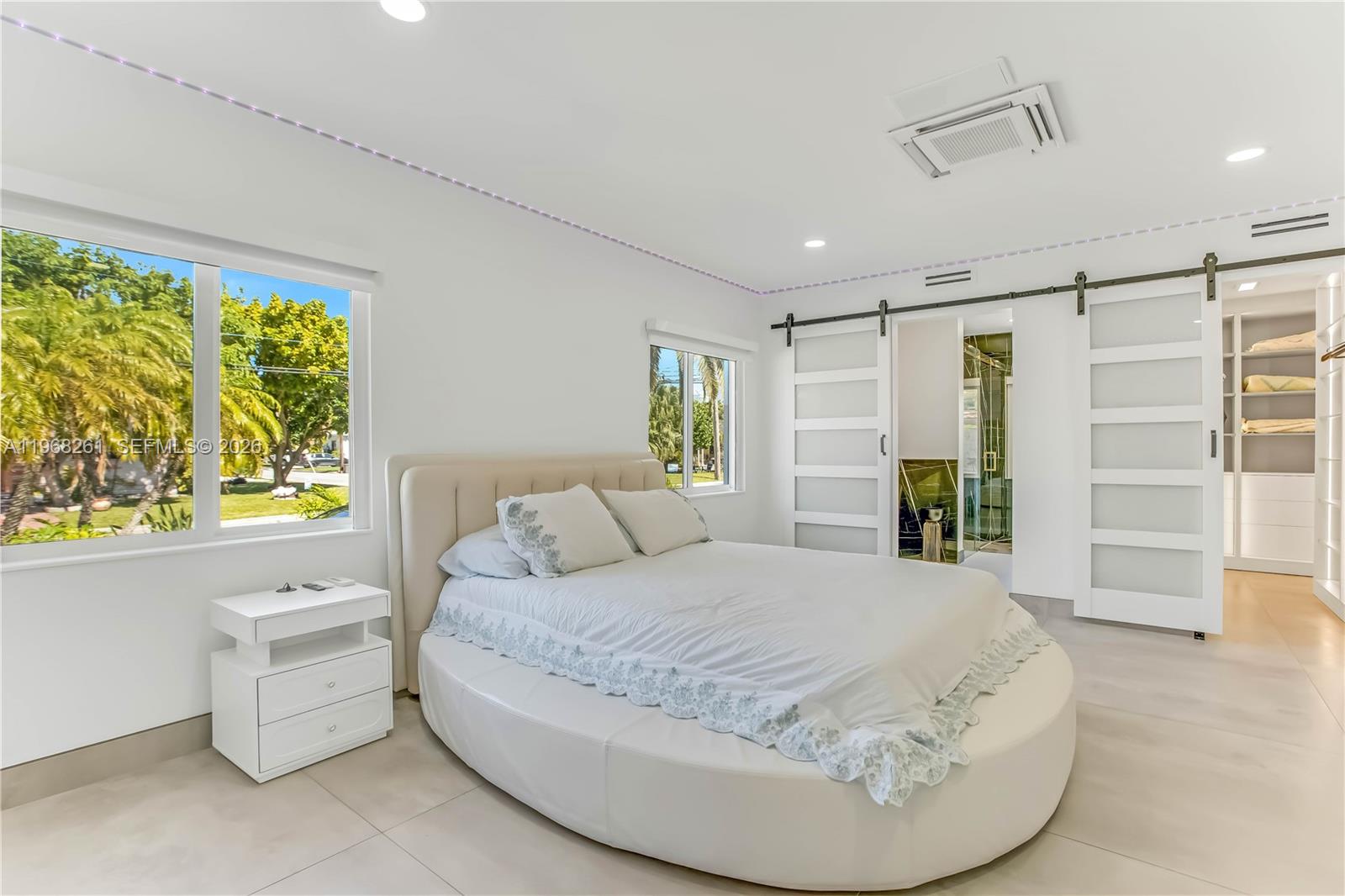 500 94th Street Surfside, FL 33154 - Photo 34 of 47 a spacious bedroom with a bed and a couch