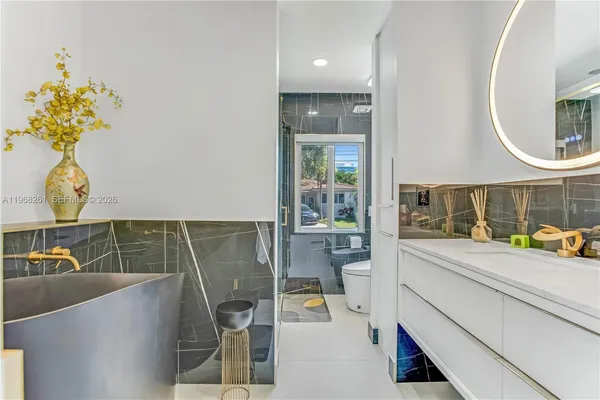 a bathroom with a glass shower door and a sink