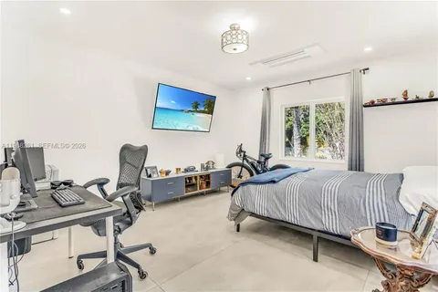 a view of a hallway with workspace and living room