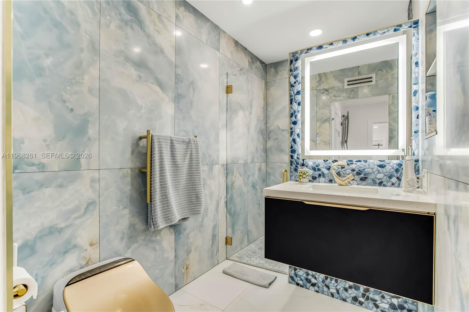 500 94th Street Surfside, FL 33154 - Photo 40 of 47 a bathroom with a sink and a mirror