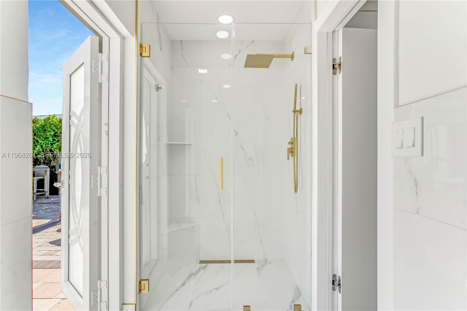 500 94th Street Surfside, FL 33154 - Photo 45 of 47 a bathroom with a shower and a glass door