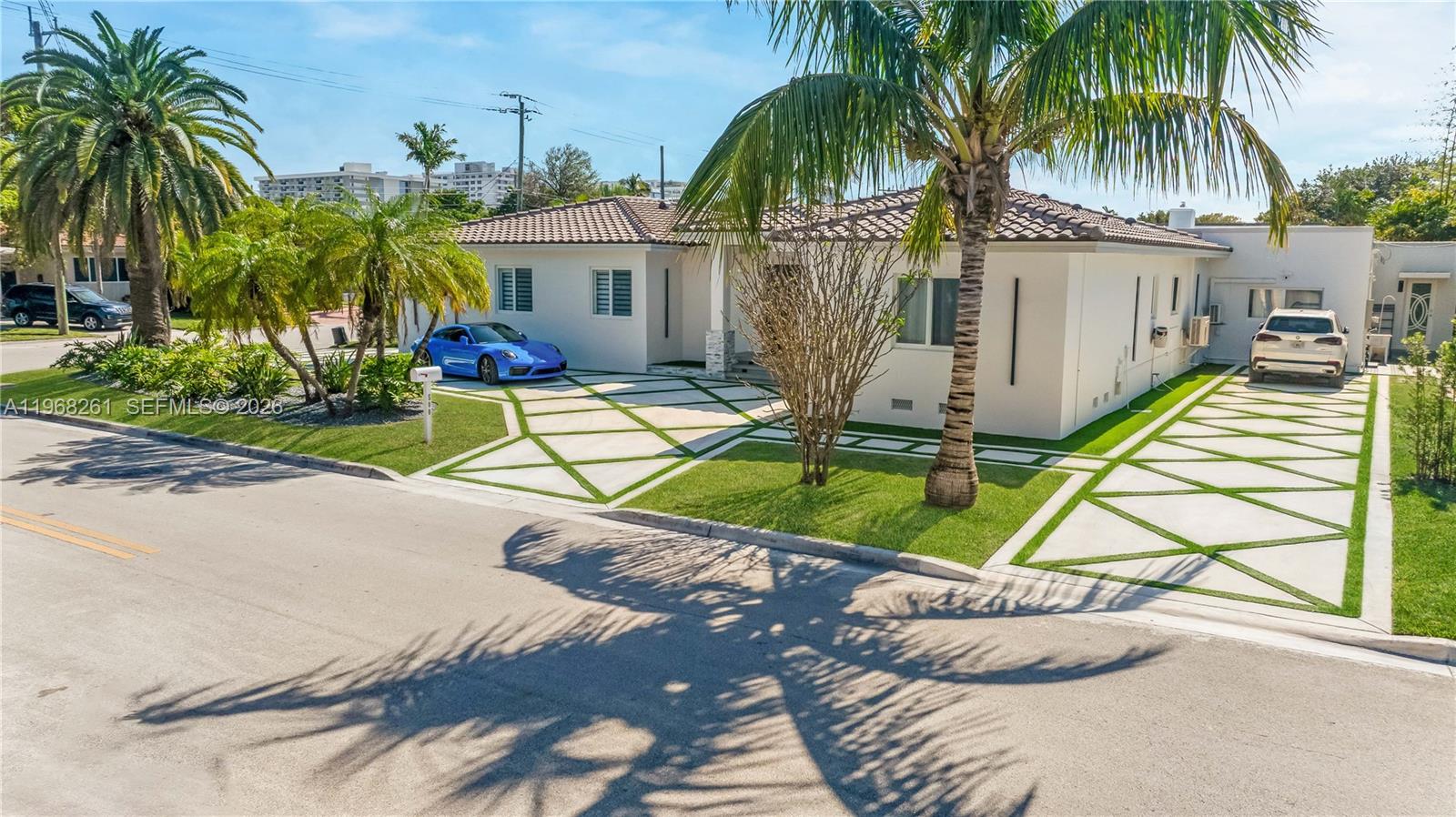 500 94th Street Surfside, FL 33154 - Photo 6 of 47 a house with palm tree in front of it