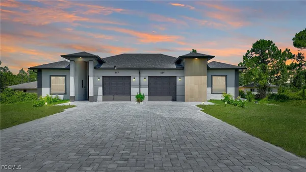 a front view of a house with a yard and garage