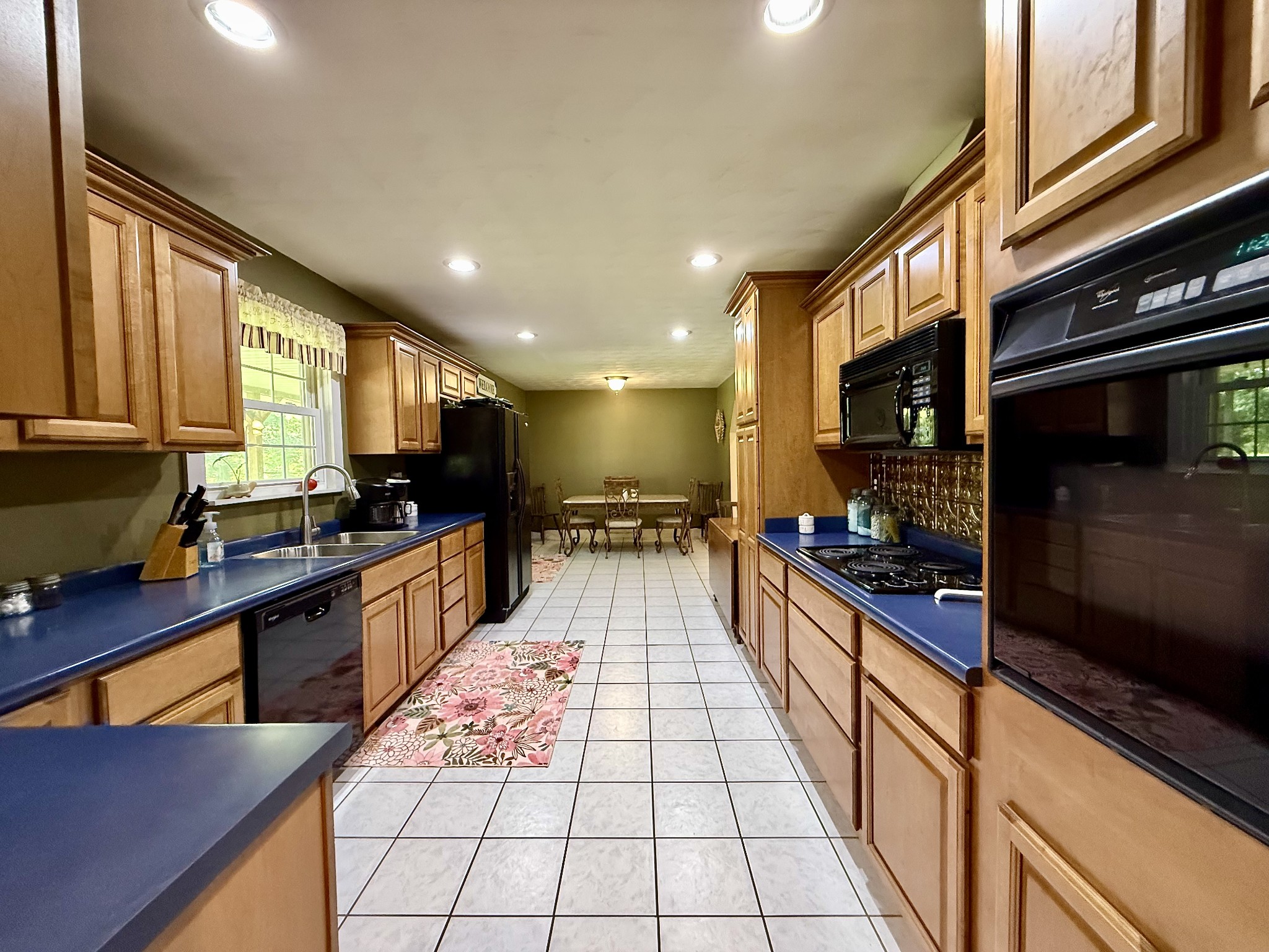 1086 Brown Mill Road McEwen, TN 37101 - Photo 17 of 44 a large kitchen with stainless steel appliances granite countertop a stove top oven a sink dishwasher a dining table and chairs with wooden floor