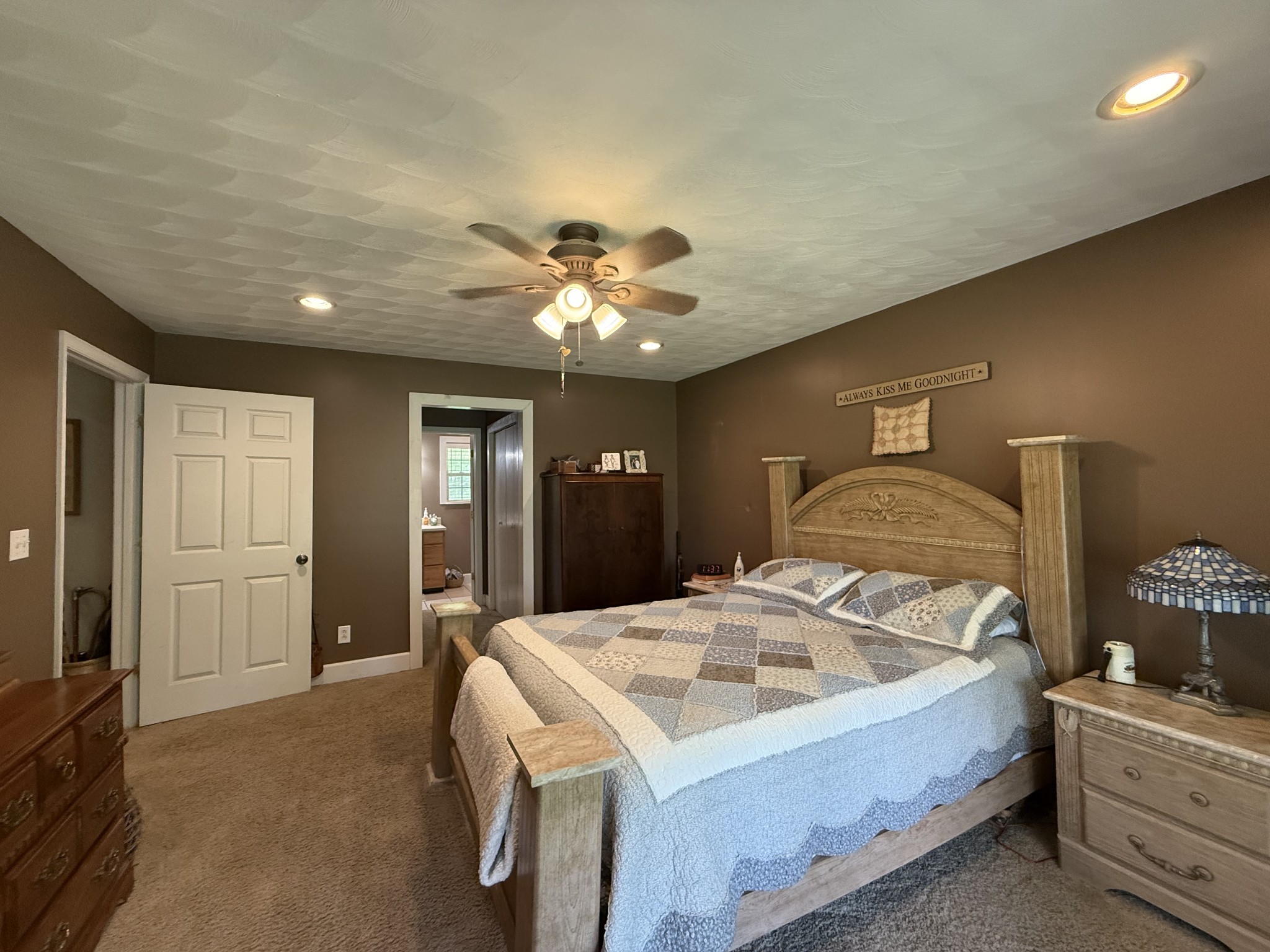 1086 Brown Mill Road McEwen, TN 37101 - Photo 30 of 44 a spacious bedroom with a bed and a chandelier