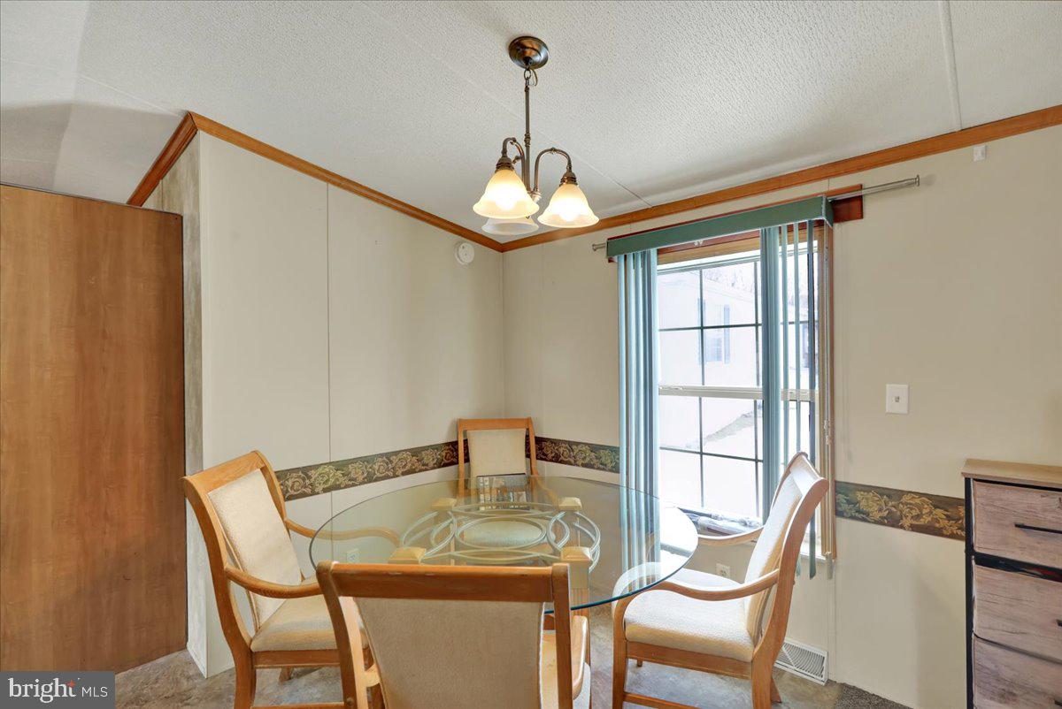125 Tuckerton Road, Unit 916 Reading, PA 19605 - Photo 8 of 19 a dining room with furniture and window